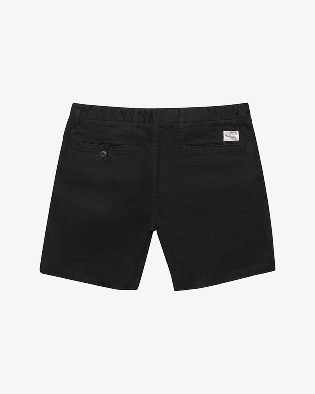 Black slim fit short with zip fly closure, back welt pockets, coin pocket detail, 63% poly 34% cotton 3% spandex twill fabrication with a garment wash