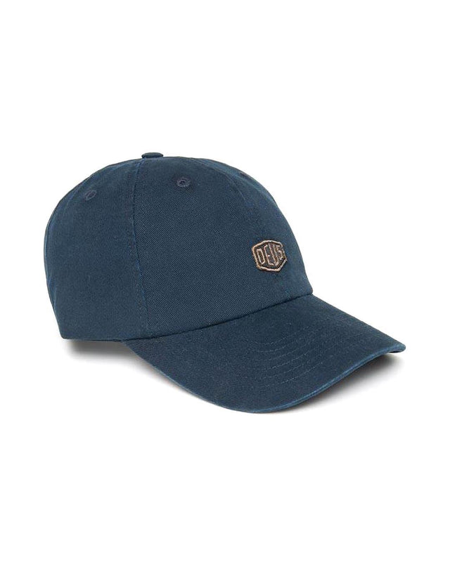 Navy 6 panel dad cap with front shield badge and self fabric adjuster, 100%  cotton twill with a heavy garment wash