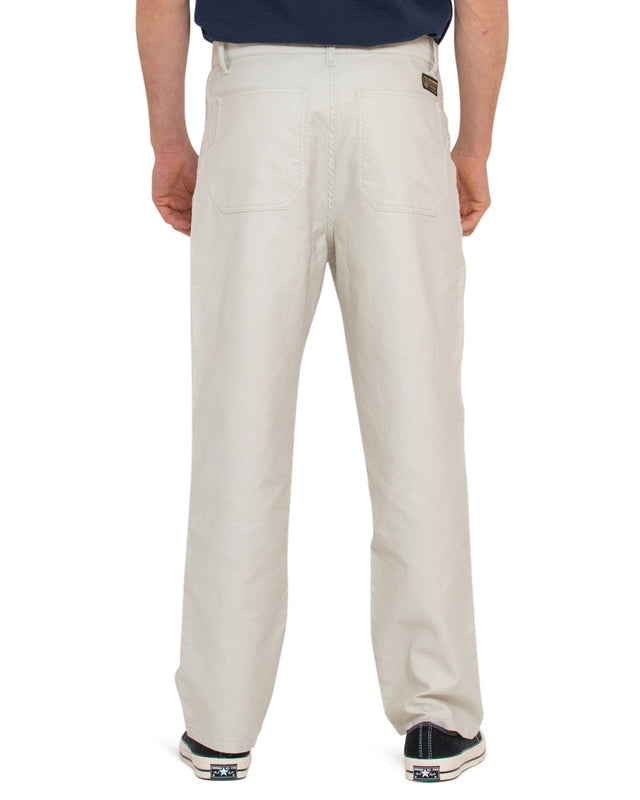 white relaxed slightly tapered fit military pant with deck patch pockets, shank fly opening, woven branded label above back pocket, 100% cotton whipcord fabrication with a heavy enzyme stone wash