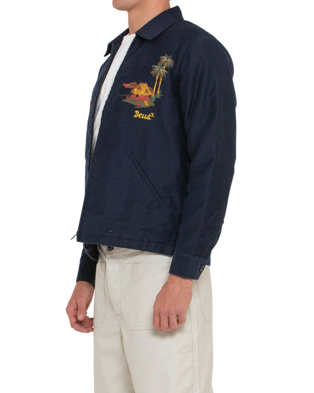 navy regular fit jacket with embroidered chest and back art, zip front, lower jet pockets. 100% cotton sateen fabrication with a heavy garment wash