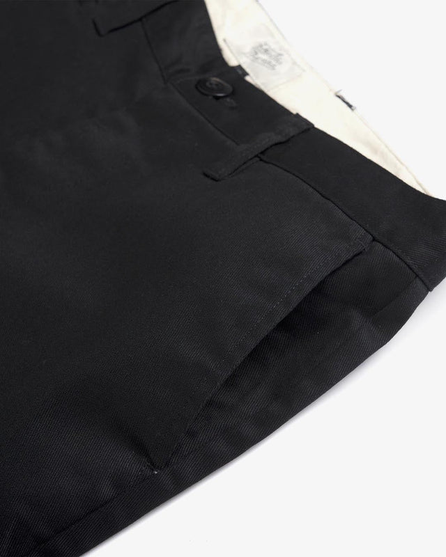 Black slim fit short with zip fly closure, back welt pockets, coin pocket detail, 63% poly 34% cotton 3% spandex twill fabrication with a garment wash