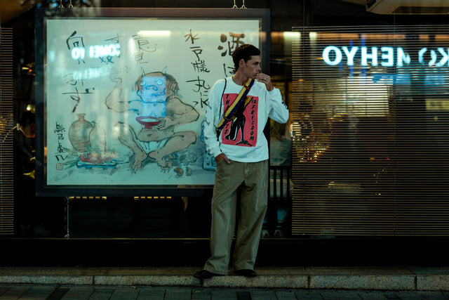 FW26 Records Model in White Long Sleeve Standing in Front of Ramen Store - 4:5 Crop