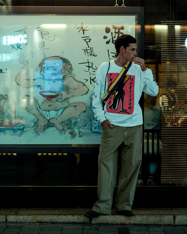 FW26 Records Model in White Long Sleeve Standing in Front of Ramen Store - 4:5 Crop