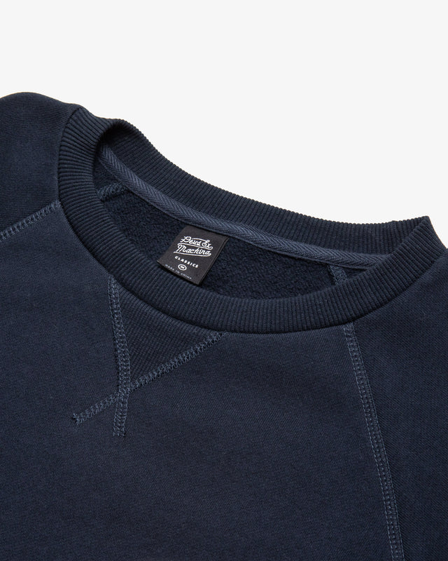 Navy regular fit classic raglan crew with chest art and address back print, 380gm oe 100% cotton brushed back fleece fabrication with a garment wash